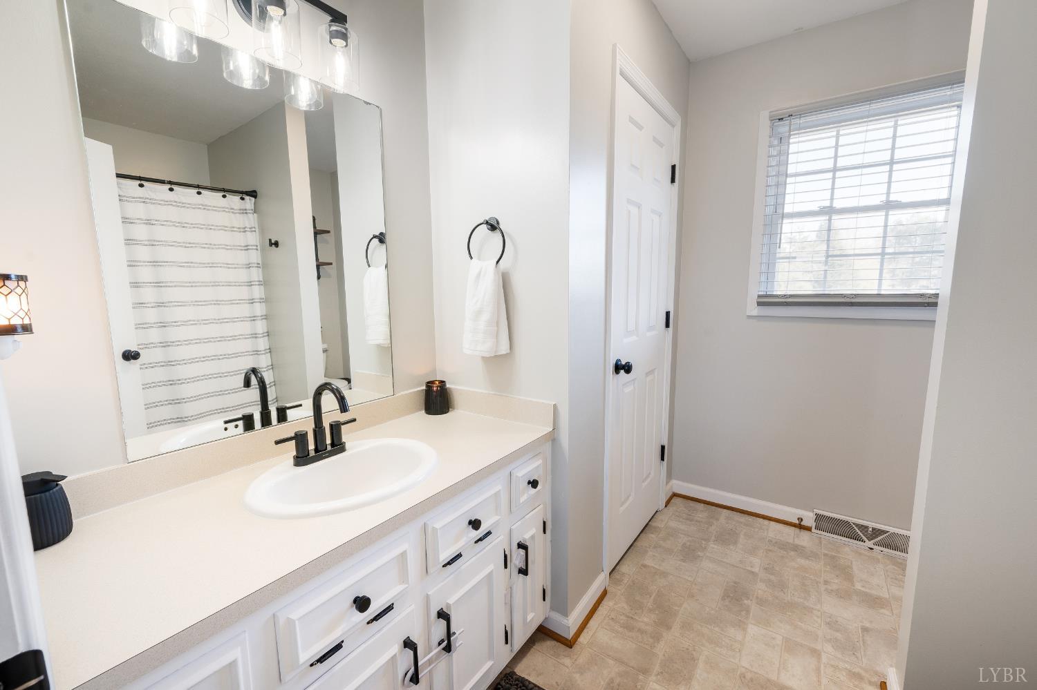 746 Church Street Appomattox, VA 24522 - Photo 16 of 36 a bathroom with a sink double vanity and a mirror