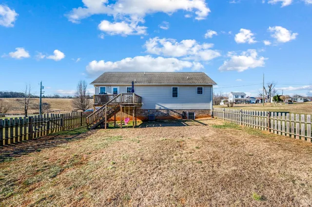 a view of a balcony with wooden floor and outdoor seating