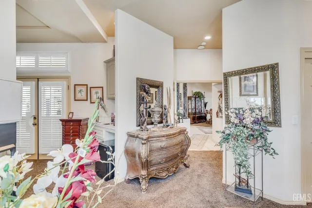 a dining room filled with lots of furniture and a chandelier
