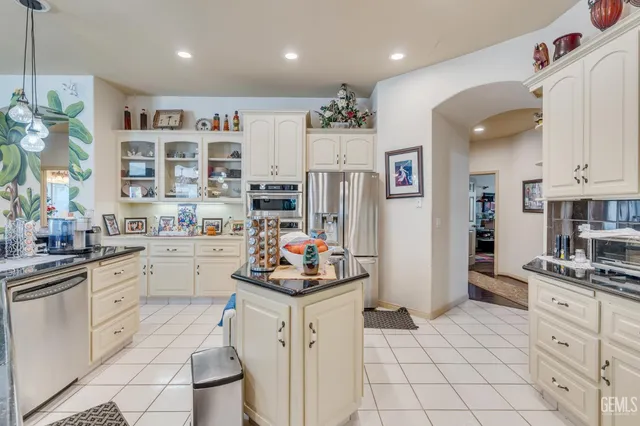 a bedroom with bed and a chandelier
