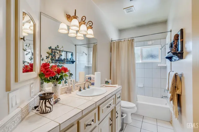 a living room with furniture a chandelier and a window