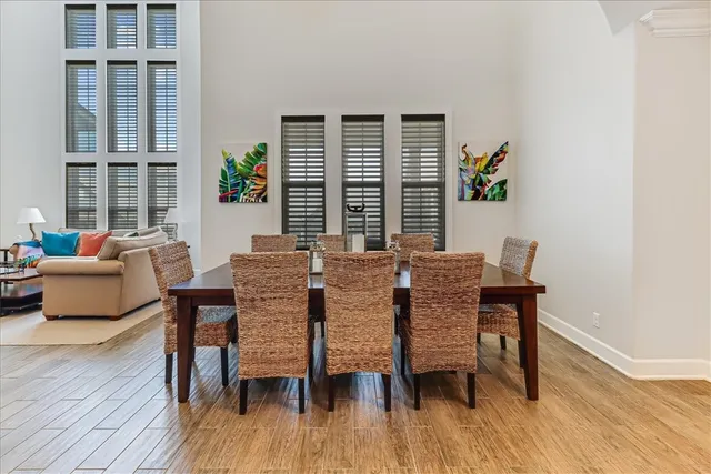 a dining room with furniture window and wooden floor