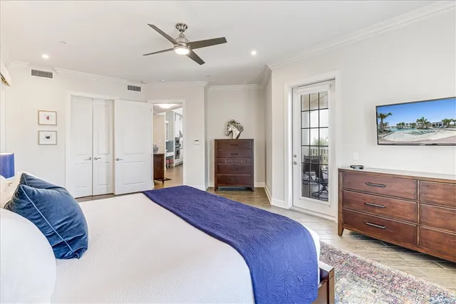 a spacious bedroom with a bed and a dresser