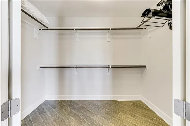 a view of a room with wooden floor and a window