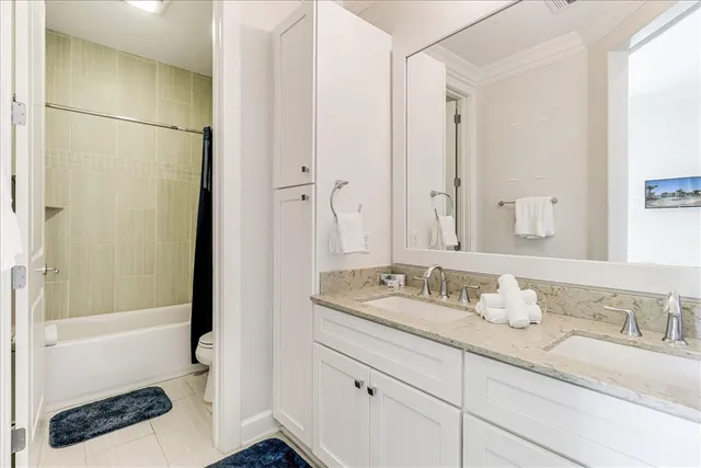 a bathroom with a granite countertop sink and a mirror a bathtub