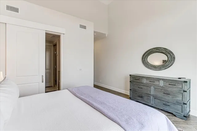 a bedroom with a bed and a dresser