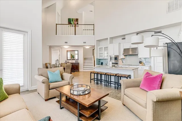 a living room with furniture and kitchen view