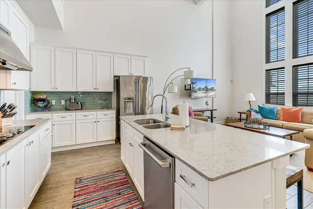a kitchen with a stove a sink dishwasher and a refrigerator