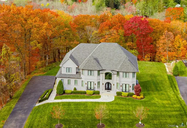 a aerial view of a house with swimming pool next to a yard