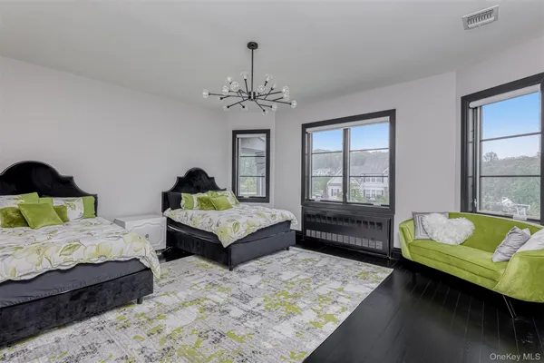 a bedroom with two beds and a couch