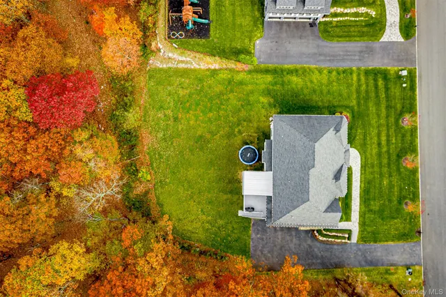 an aerial view of a house with a garden and swimming pool