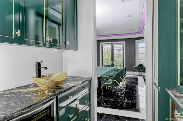 a view of a dining room with furniture a chandelier and wooden floor