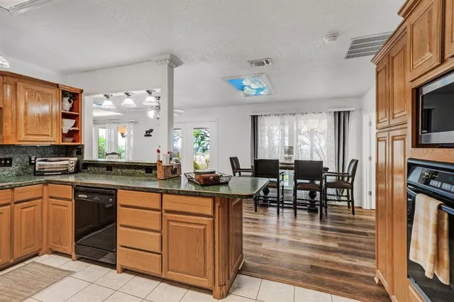 a kitchen with granite countertop stainless steel appliances and counter space