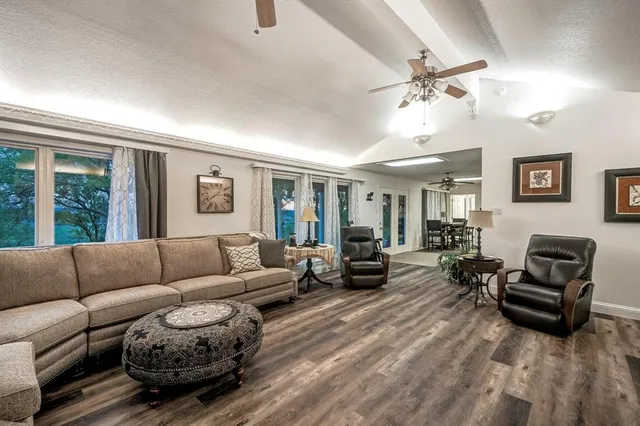 a living room with furniture a fireplace and a flat screen tv