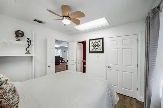 a kitchen with stainless steel appliances kitchen island granite countertop a sink dishwasher a stove and a dining table with wooden floor