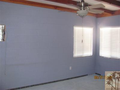 8526 Old Vine Road Joshua Tree, CA 92252 - Photo 19 of 19 a view of a livingroom with a ceiling fan and window
