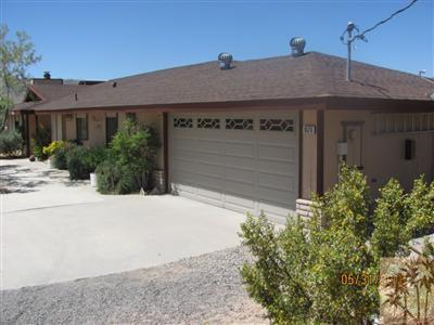 8526 Old Vine Road Joshua Tree, CA 92252 - Photo 5 of 19 a front view of a house with a garage