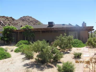 8526 Old Vine Road Joshua Tree, CA 92252 - Photo 8 of 19 a view of a house with a yard and a wooden fence