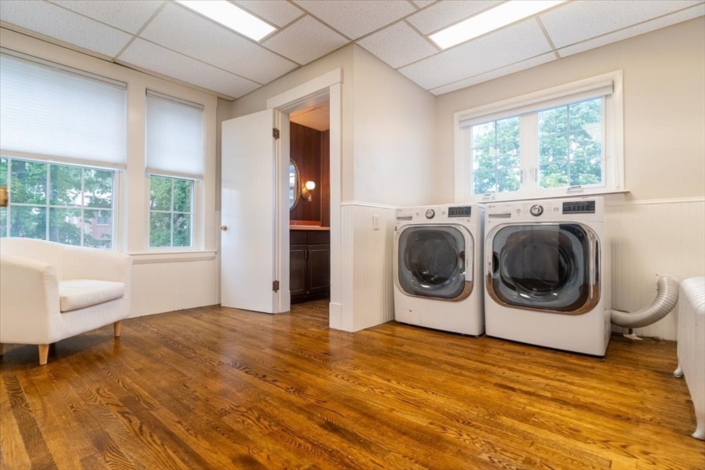 132 Church Street, Unit 1 Waltham, MA 02452 - Photo 13 of 42 a view of a big room with wooden floor and furniture