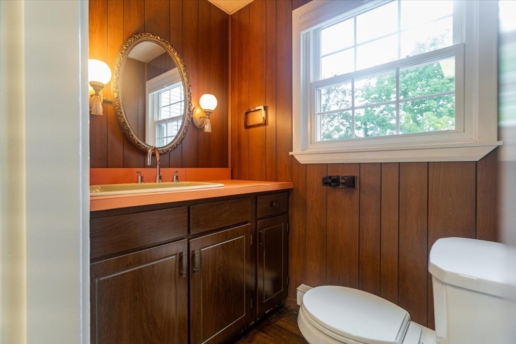 132 Church Street, Unit 1 Waltham, MA 02452 - Photo 14 of 42 a bathroom with a toilet a sink and mirror