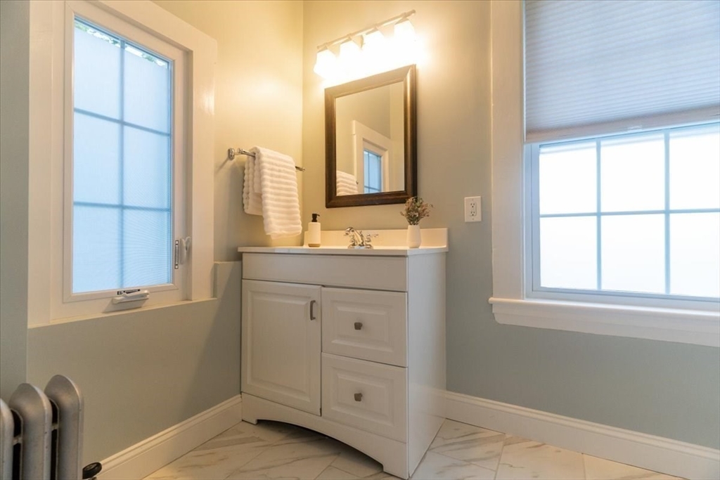 132 Church Street, Unit 1 Waltham, MA 02452 - Photo 20 of 42 a bathroom with a double vanity sink and mirror