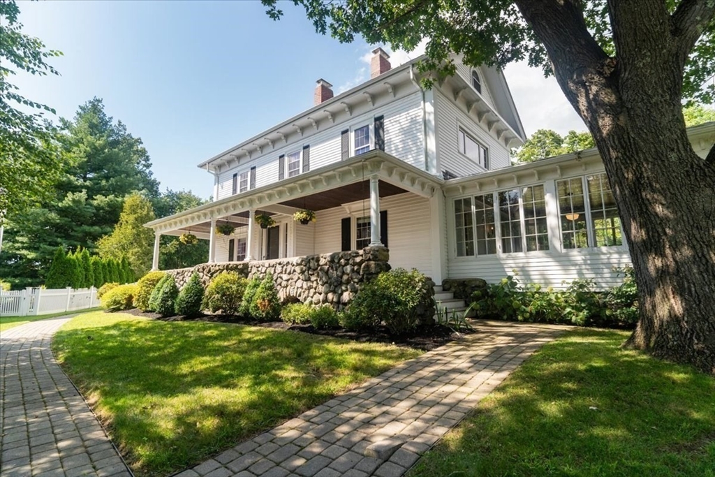 132 Church Street, Unit 1 Waltham, MA 02452 - Photo 2 of 42 a front view of a house with a garden and trees