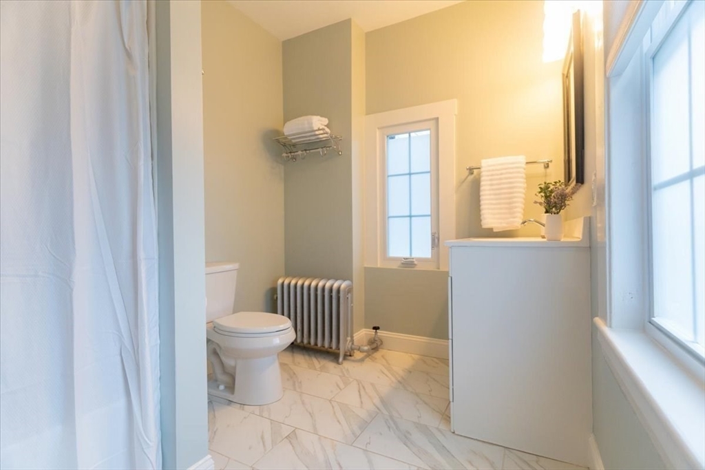 132 Church Street, Unit 1 Waltham, MA 02452 - Photo 21 of 42 a bathroom with a toilet and a window