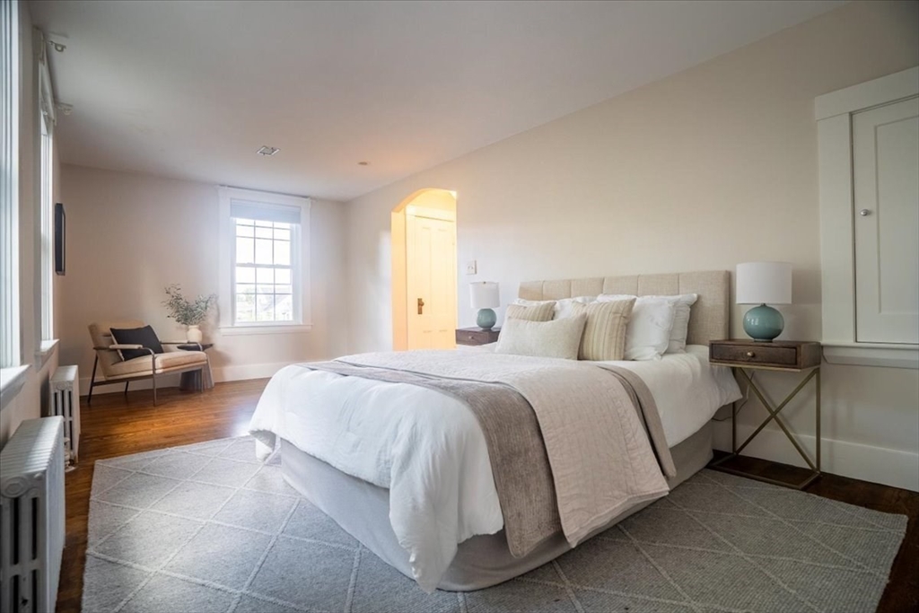 132 Church Street, Unit 1 Waltham, MA 02452 - Photo 22 of 42 a spacious bedroom with a bed and a couch
