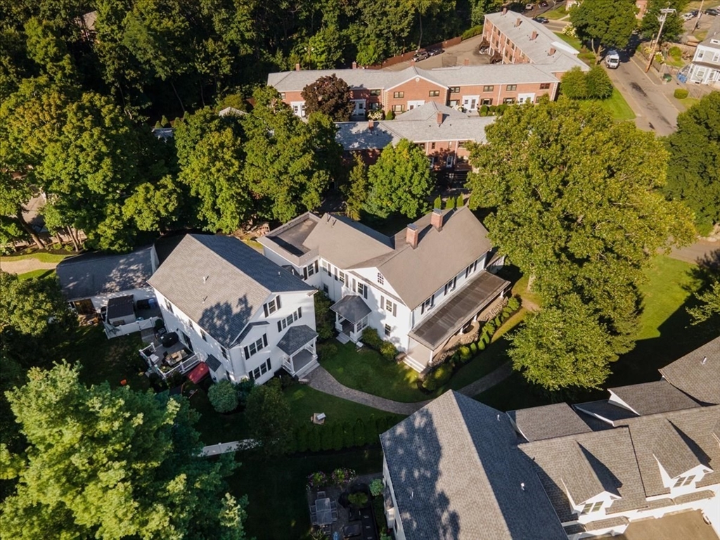 132 Church Street, Unit 1 Waltham, MA 02452 - Photo 40 of 42 an aerial view of a house with a garden and trees