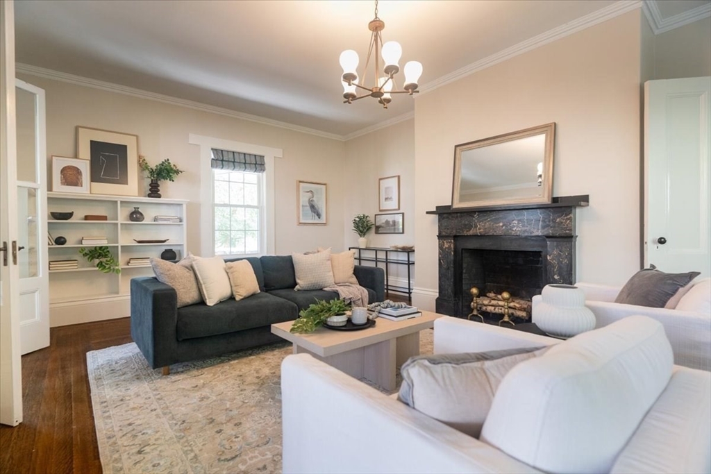132 Church Street, Unit 1 Waltham, MA 02452 - Photo 5 of 42 a living room with furniture and a fireplace