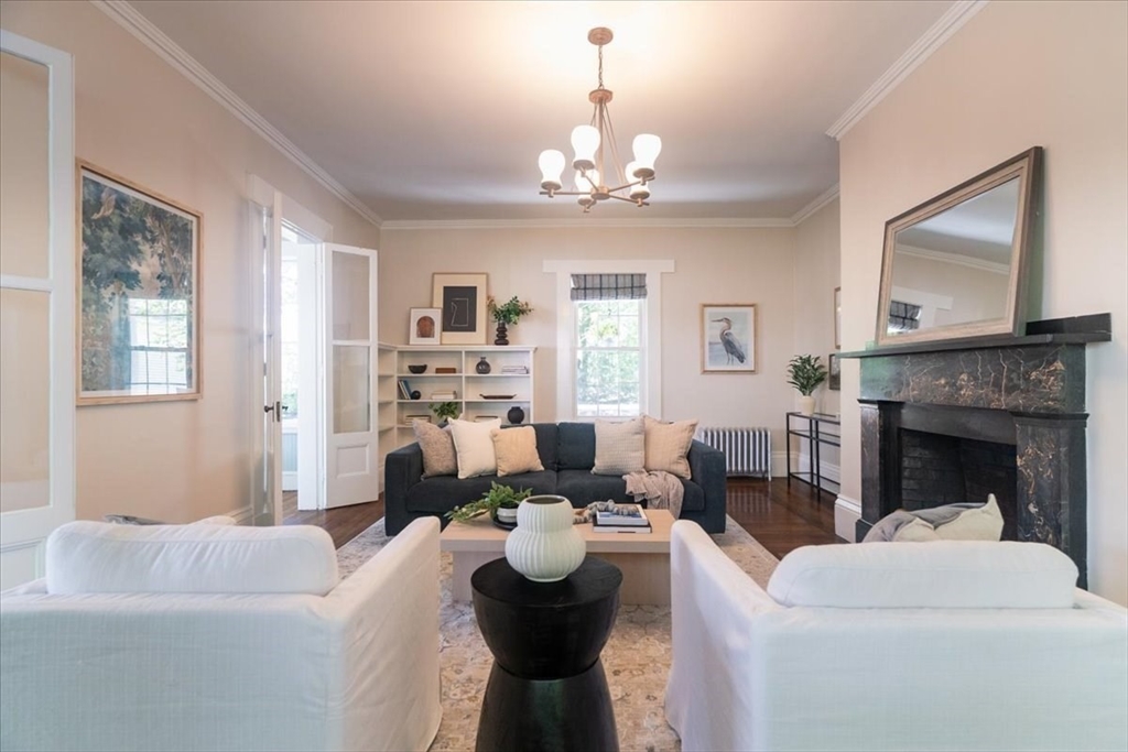 132 Church Street, Unit 1 Waltham, MA 02452 - Photo 6 of 42 a living room with furniture a fireplace and a chandelier