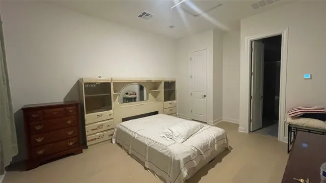 a bedroom with a bed and a dresser