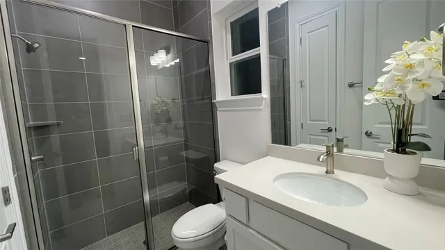 a bathroom with a sink toilet and shower