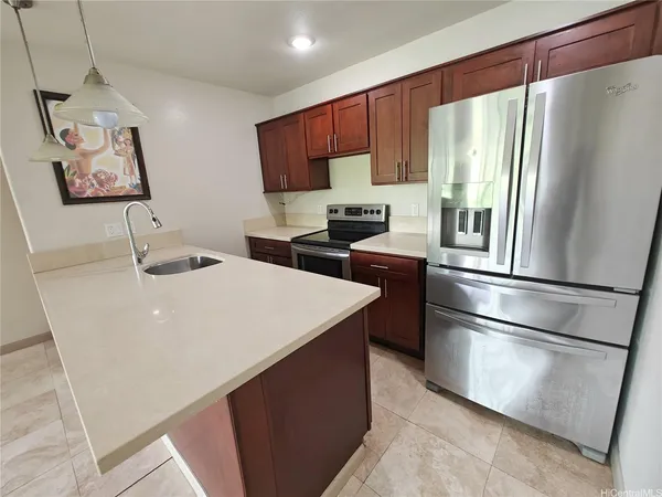 a kitchen with stainless steel appliances a refrigerator sink and microwave