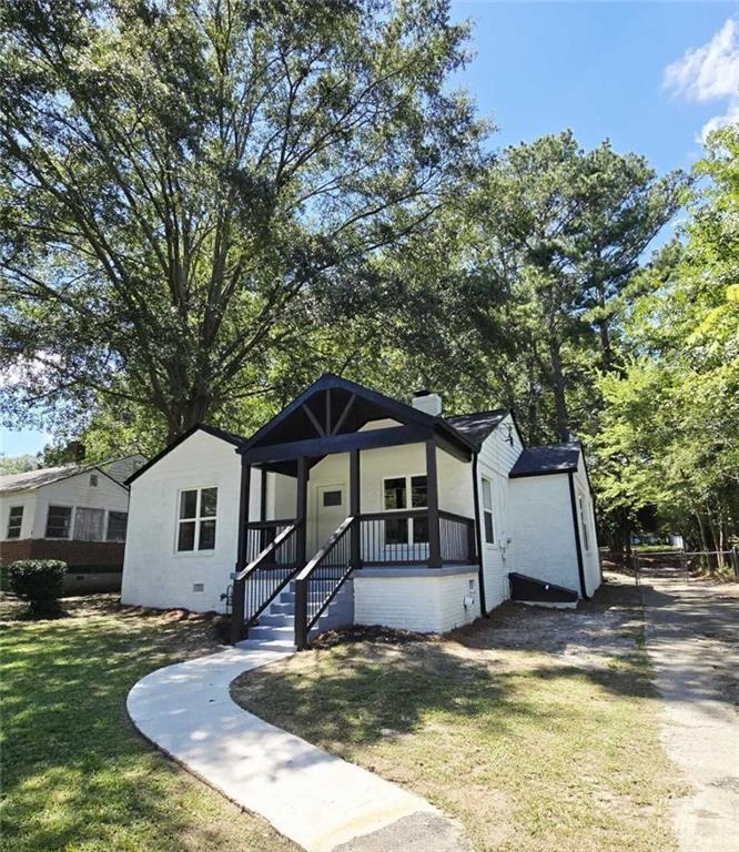 a front view of a house with a yard garage and outdoor seating