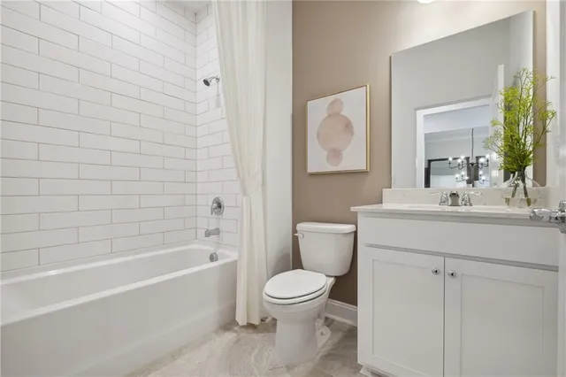 a bathroom with a toilet a sink a mirror and bathtub
