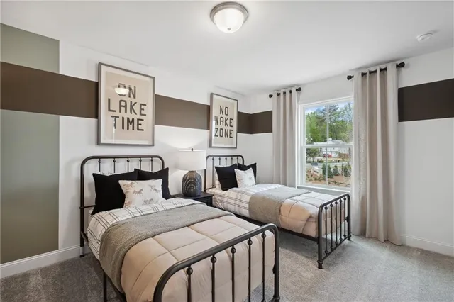 a bedroom with two beds and a large window