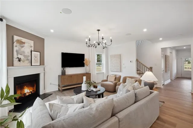 a living room with furniture a fireplace and a flat screen tv