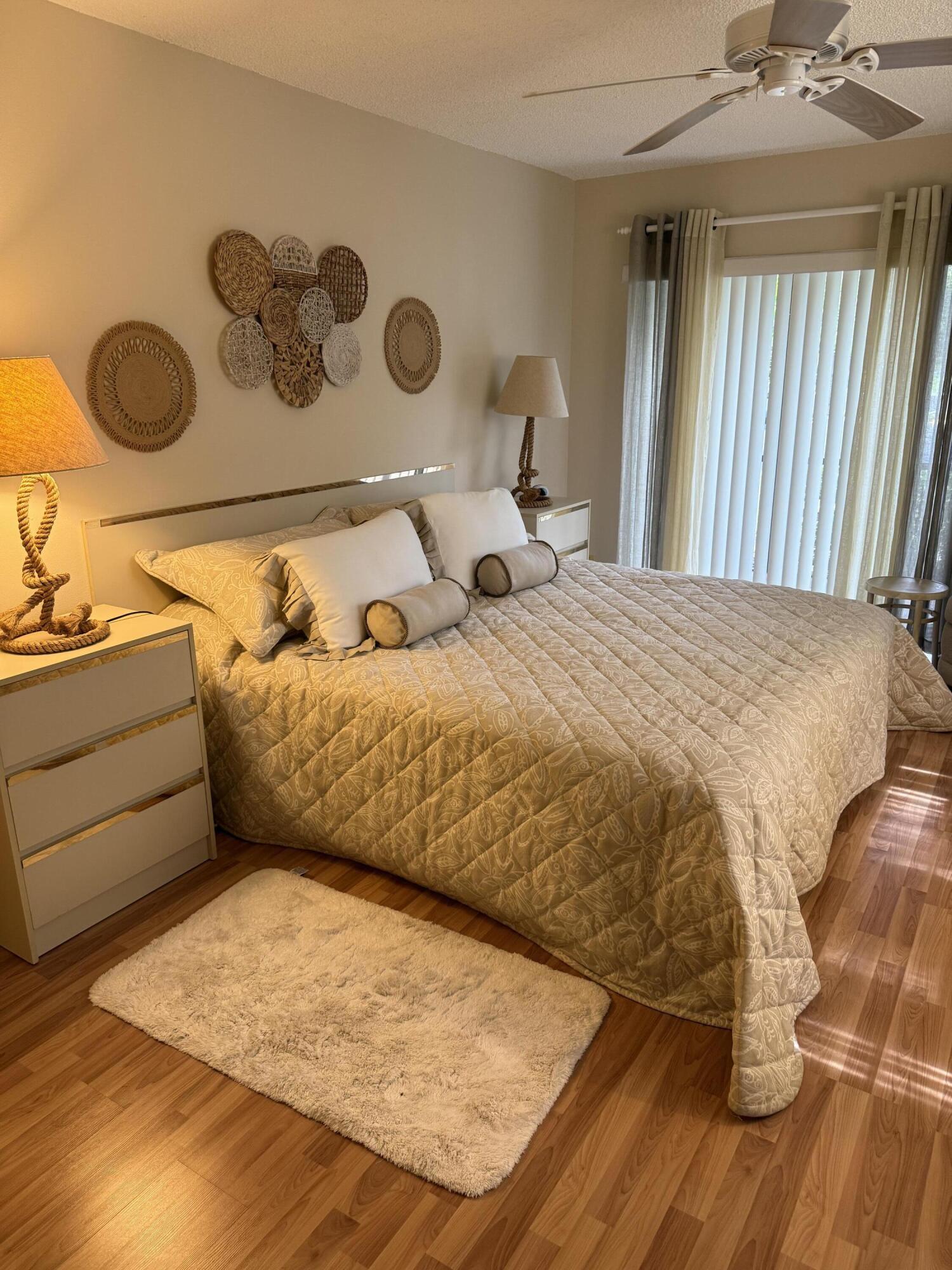 147 Deer Creek Boulevard, Unit 402 Deerfield Beach, FL 33442 - Photo 43 of 81 a bedroom with a bed and cabinets