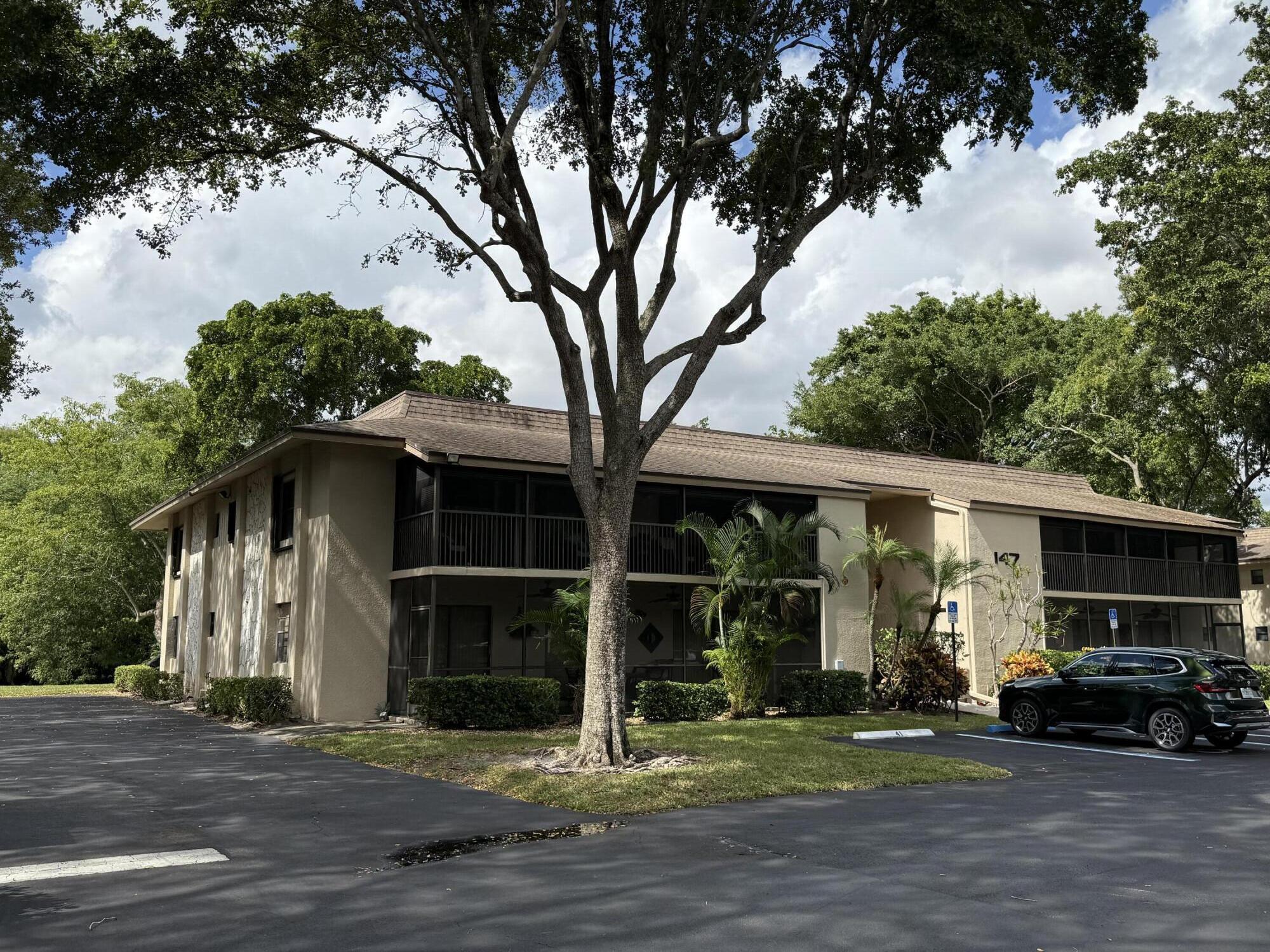 147 Deer Creek Boulevard, Unit 402 Deerfield Beach, FL 33442 - Photo 77 of 81 a view of a car park in front of house