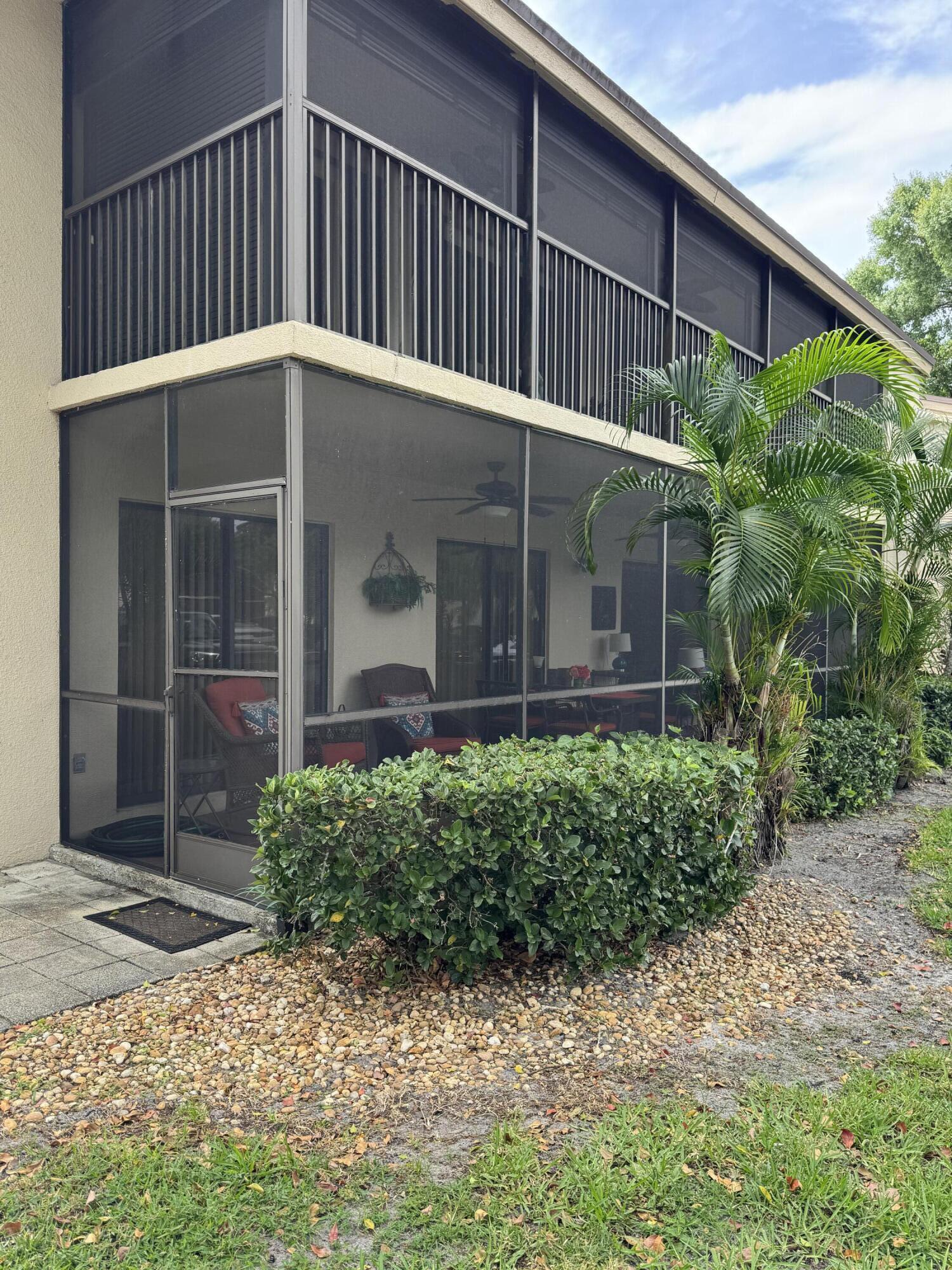 147 Deer Creek Boulevard, Unit 402 Deerfield Beach, FL 33442 - Photo 79 of 81 a view of a house with a small yard and plants