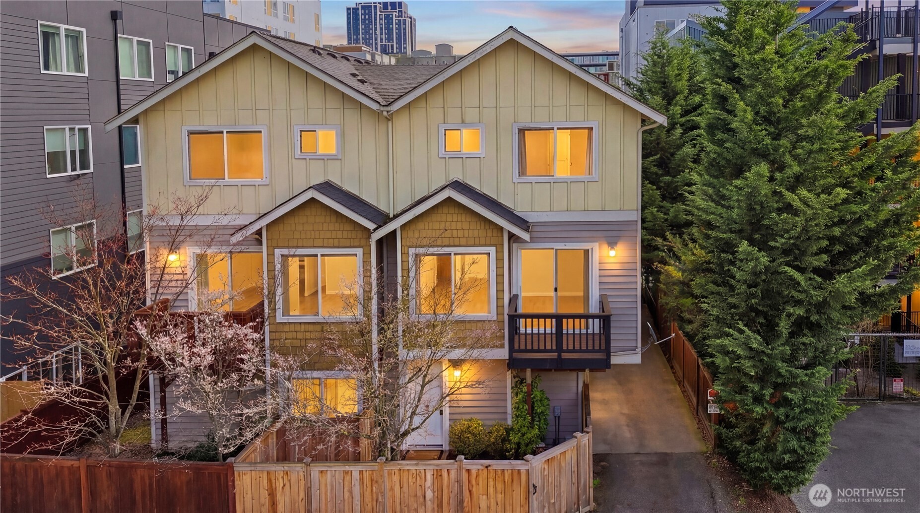 4037 7th Avenue Northeast, Unit A Seattle, WA 98105 - Photo 1 of 35 a front view of a house with a yard and balcony