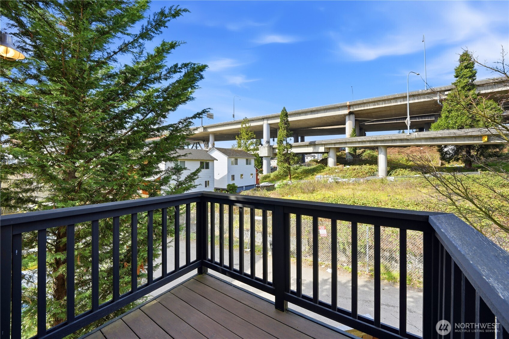 4037 7th Avenue Northeast, Unit A Seattle, WA 98105 - Photo 11 of 35 a view of a balcony with wooden floor and outdoor space