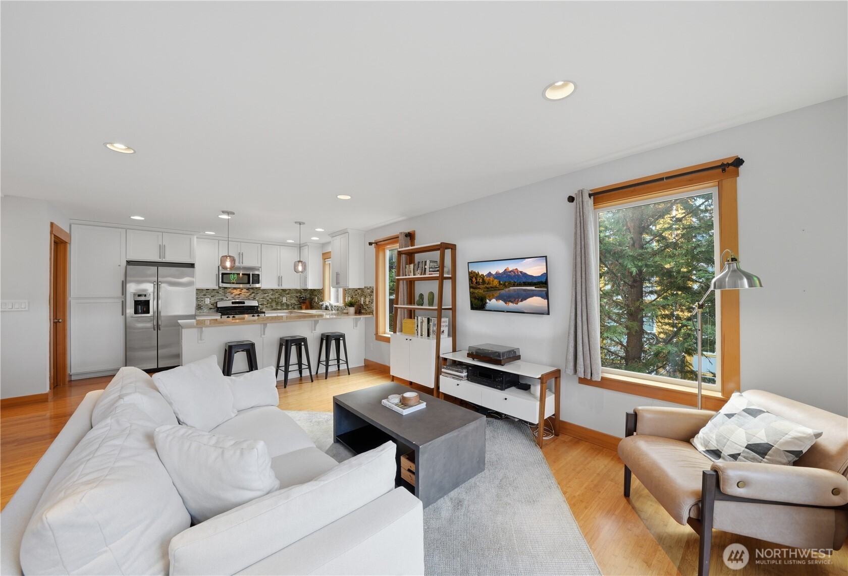 4037 7th Avenue Northeast, Unit A Seattle, WA 98105 - Photo 13 of 35 a living room with furniture kitchen view and a large window
