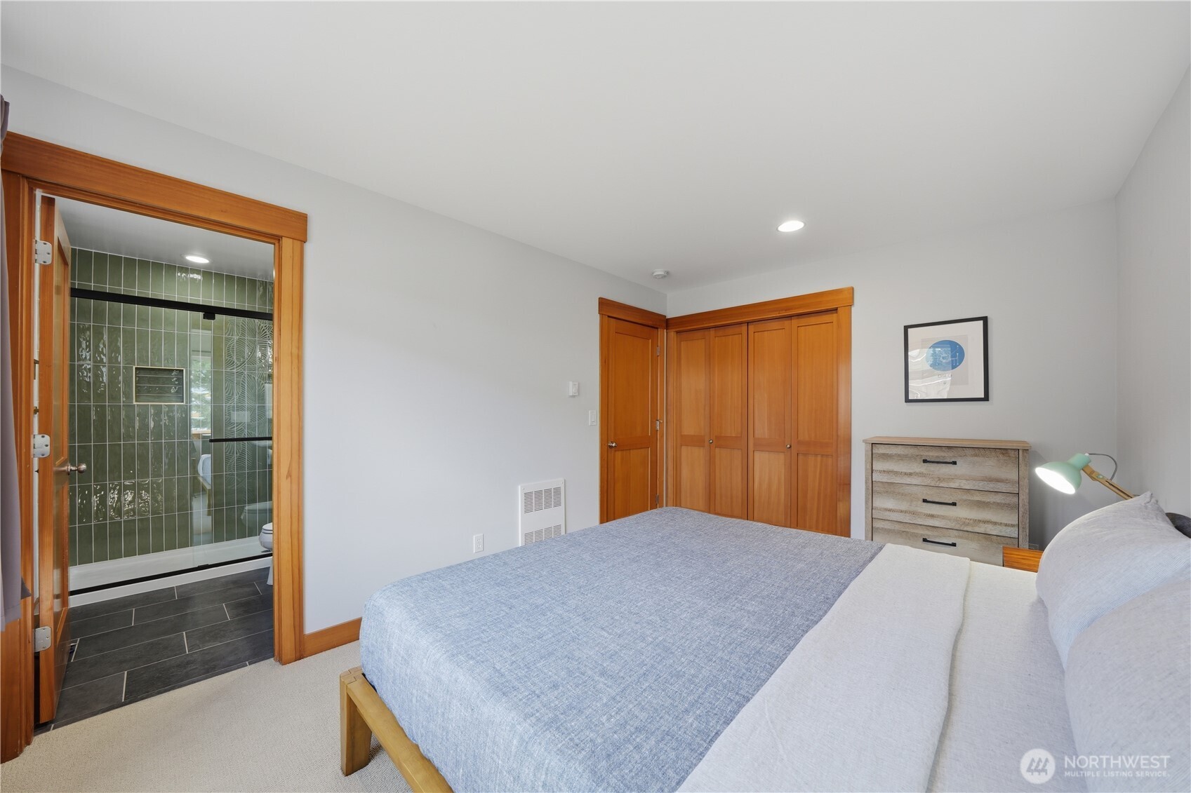 4037 7th Avenue Northeast, Unit A Seattle, WA 98105 - Photo 23 of 35 a bedroom with a large bed and a chandelier