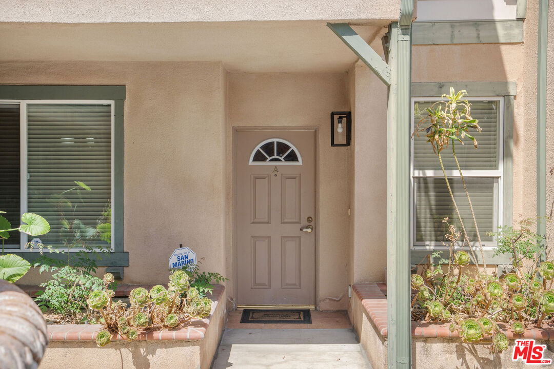 1128 West Duarte Road, Unit A Arcadia, CA 91007 - Photo 4 of 28 a view of a porch with chairs and potted plants