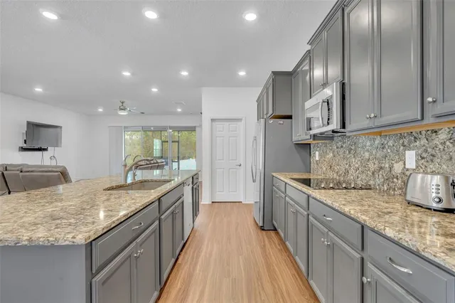 a large kitchen with stainless steel appliances granite countertop plenty wooden cabinets
