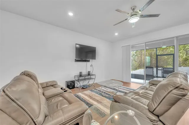 a bedroom with a bed window and a flat screen tv