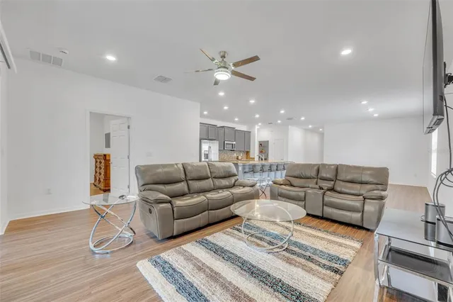 a living room with furniture and wooden floor