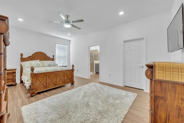 a bedroom with a bed and wooden floor